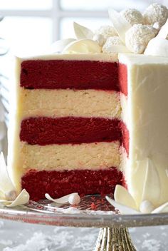 a cake with red and white frosting sitting on a plate