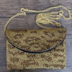 This chic mini clutch features a gold cheetah pattern and a gold strap for a wild and stylish look. Perfect for going out, this clutch bag is a great way to bring your essentials while looking fashionable. Measurements: 7”L x 0.5”W x 5”HChain Strap Measurement: 45” Elegant Gold Evening Bag With Adjustable Strap, Gold Pouch Clutch With Chain Strap, Gold Chain Strap Pouch Clutch, Chic Gold Crossbody Evening Bag, Chic Gold Evening Bag With Adjustable Strap, Trendy Brown Clutch For Party, Brown Party Clutch With Chain Strap, Gold Crossbody Clutch For Party, Trendy Gold Pouch Clutch