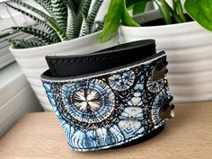 "I've made this wrapping cuff out of smooth leather with a digital print design. Choose from a brown or black leather base. It has attached elastics that hook over two rivets so this cuff will adjust to fit most wrist sizes 6 to 7.5\" in circumference. The cuff is 2\" wide at the narrowest and 2.75\" at the widest end. This cuff is quite unique, I get lots of feedback comments such as: \"I have hard to fit wrists and it fits perfectly.\" \"The leather is so soft and feels great on my skin.\" \"B Blue Cuff Bracelets For Festivals, Blue Cuff Bracelet For Festival, Adjustable Cuff Wristband, Adjustable Blue Leather Bracelet As Gift, Adjustable Blue Leather Bracelet Gift, Adjustable Blue Leather Bracelet For Festivals, Blue Cuff Bracelet For Festivals, Blue Cuff Bracelet Gift, Adjustable Blue Cuff Bracelet For Festivals