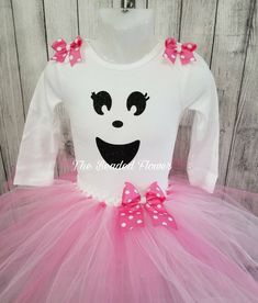 "Halloween Orders Last day to order for guarantee delivery for halloween will be Oct. 22. Thank you. This adorable ghost costume will look adorable on any little one. Please select the size needed when ordering. Top will be a long sleeve bodysuit/shirt with a glitter vinyl ghost face image on the front. The tutu skirt will be a mixture of pink tulle made on a crochet band with two layers and a removable bow on an alligator clip. Please add in the personalized box if you want the shoulder bows ad Cute White Halloween Costume, Cute Halloween Costume Tutu Dress, Cute Tutu Dress For Halloween Costume, Halloween Princess Costume With Long Sleeves, Princess Halloween Costume With Long Sleeves, Princess Costume With Long Sleeves For Halloween, Pink Fitted Tutu Dress For Halloween, Pink Long Sleeve Halloween Dress, Princess Style Long Sleeve Halloween Costume