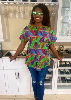 Beautiful African print top for women with African fabric 100% cotton. This colorful Ankara summer blouse is versatile, flattering, and available for all sizes including plus sizes. Ankara blouse with split neckline. African shirt for women with side slits, pleats, and a fun curved hem.  Wear this African top over pants, skirts, shorts, or jeans, and cinch it with your own belt for a different look- see all the inserted photos. This item will be specially handcrafted for you upon purchase. 🛑 Accessories & head tie on model are not included, please click below to purchase a matching head tie. https://www.etsy.com/listing/756336810/africa-head-wrap-ankara-headwraps?click_key=015272619699118e8d91495eb65f63fd178c2c77%3A756336810&click_sum=eb658d78&ref=shop_home_active_1 *️⃣ MEASUREMENT GUIDE: Relaxed Fit Multicolor Patterned Top, Colorful Pattern Crew Neck Top, Multicolor Crew Neck Top For Vacation, Casual Colorful Patterned Relaxed Fit Top, Green Printed Crew Neck Blouse, Multicolor Short Sleeve Tops For Vacation, Cotton Graphic Print Blouse For Vacation, Colorful Pattern Cotton Top With Short Sleeves, Colorful Patterned Tops With Relaxed Fit For Summer