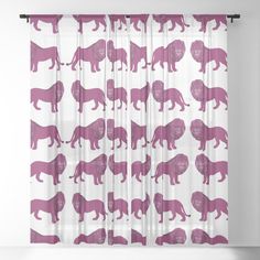 the curtain is decorated with pink silhouettes of animals on white and purple background,