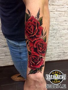 a man with a red rose tattoo on his arm