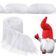 a red and white gnome hat next to two rolls of fluffy white yarn on a white background