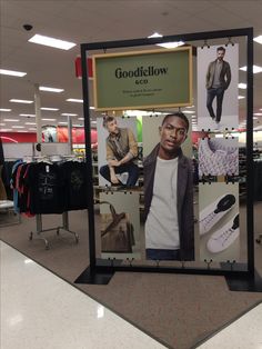 an advertisement for goodfelllow in the middle of a shopping mall with men's clothing on display