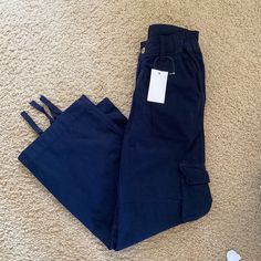 Relaxed, Straight-Leg Cargo Pants With 6 Pockets, Adjustable Elastic Bands At The Waist And Lace Adjusters To The Cuff Of Each Leg. Fabrics: 100% Cotton Measurements: 9"(23 Cm) Rise, 30"(77 Cm) Inseam, 26"(66 Cm) Waist( Stretches) Made In: China Mid-rise Blue Cargo Pants With Pockets, Blue Mid-rise Cargo Pants With Pockets, Blue Utility Cargo Pants For Work, Full-length Denim Blue Pants With Side Pockets, Blue Straight Leg Pants With Cargo Pockets, Full Length Denim Blue Pants With Side Pockets, High Waist Blue Cargo Pants For Work, Casual Blue Full-length Cargo Pants, Blue Straight Leg Bottoms With Cargo Pockets