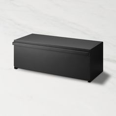 a large black box sitting on top of a white counter next to a marble floor