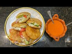 a plate with some food on it next to an orange sauce