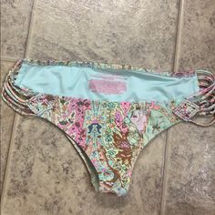 Never Worn. Strappy Victoria Secret Cheeky Bikini Swim Bottoms. Pink Teal Gold Green Victoria's Secret Bottoms For Sunbathing In Summer, Victoria's Secret Summer Bottoms For Sunbathing, Pink Beachy Bottoms For Beach Party, Pink Tie-side Bottoms For Beach Season, Pink Printed Pool Bottoms, Victoria's Secret Beach Bottoms For Spring, Trendy Victoria's Secret Swimwear For Spring, Trendy Pink Pool Bottoms, Pink Beach-style Bottoms For Sunbathing