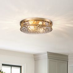 a light fixture in the middle of a kitchen