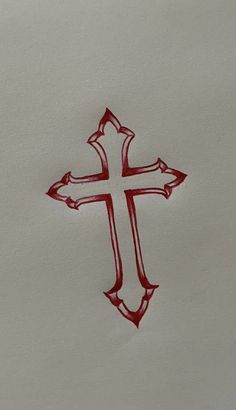 a drawing of a red cross on white paper