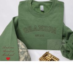 "Custom Embroidered Sweatshirt Name On Sleeve With Heart Grandpa Shirt With Date Daddy Est Year Shirt Gift For New Dad Father's Day Gift Welcome to my store! How to order: -Select the shirt size and color. -Add Names, Color Thread, Year In personalization box -Add to cart. Easy and simple. Material: -50% Cotton, 50% Polyester -Fitted sweatshirts so if you like a little loose size up Care instructions: -Machine cold wash, inside out, with like colors. Only non-chlorine bleach. -Tumble dry low. -Medium iron. Do not iron decoration. -Size chart is available in the listing photos. All measurements are approximate. Measurements may vary about 1\" less or more. Return&exchange policy: -All sales are final. No returns, no exchanges due to t-shirts are being made to order, but please contact me fo Grandpa Sweater Aesthetic, Grandpa Sweatshirt, Embroidered Products, Gift For New Dad, Sweater Aesthetic, July Fashion, Gift For Grandpa, Grandpa Shirt, Grandpa Sweater