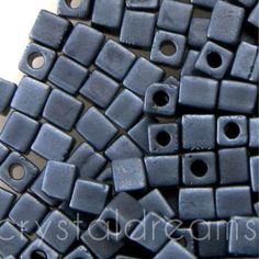 blue square beads are stacked together on the table