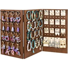 an open brown case with earrings and earring holders on it's sides, hanging from the wall