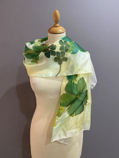 Hand painted silk scarf, a beautifully unique gift for her. Unique and original wearable art, detailed flower designed scarf. This hand painted scarf is a mix of greens with fine gold details. A beautiful dash of colour to complement your look.  This exclusive designer Délisa scarf is hand painted in our atelier, in the South of France. You could say it with flowers, or you could say it with this unique and original gift! A gift to last a lifetime! * 100% silk scarf with rolled edges * Hand pain Artistic Hand Painted Green Silk Scarf, Green Floral Print Scarves As Gift, Green Floral Print Scarf For Gift, Artistic Green Silk Scarf With Floral Print, Hand Painted Green Silk Scarf, Artistic Hand Dyed Green Silk Scarf, Artistic Green Silk Scarf As A Gift, Artistic Hand-dyed Green Scarves, Elegant Handmade Green Silk Scarf