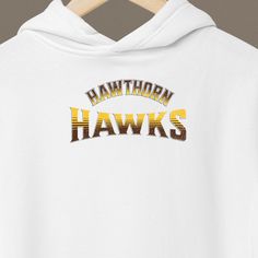 🟤🟡 Unleash Your Hawks Spirit with Our Exclusive Hoodie! 🟡🟤 Elevate your game day ensemble with our Hawthorn Hawks hoodie - a must-have for every proud and passionate supporter of the Brown and Gold! Crafted with the finest materials and adorned with iconic team motifs, this Aussie-made unisex hoodie is more than just apparel - it's a declaration of allegiance. Here's why it's a must-have for every Hawks supporter: 🏉 Ultimate Comfort: Wrap yourself in luxury with our plush blend of cotton and polyester, ensuring unbeatable softness and warmth on even the chilliest of days. Embrace relaxation without sacrificing style. 🧥 Classic Fit, Modern Flair: Designed for both comfort and flair, our hoodie features a classic fit complemented by a spacious kangaroo pocket for everyday practicality. Hooded Tops With Team Logo For Fans, Hooded Tops With Team Logo For Fan Gear, Collegiate Hooded Tops For Game Day, Game Day Fan Apparel Tops With Drawstring Hood, Collegiate Team-colored Hoodie For Game Day, Collegiate Hoodie In Team Colors For Game Day, Game Day Fan Apparel Hoodie, Team-colored Hooded Sweatshirt For Game Day, Team-colored Hoodie With Team Logo For Game Day