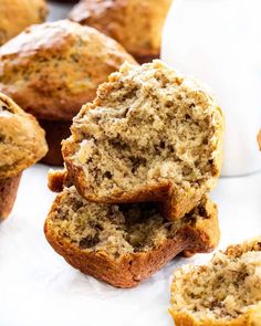 several muffins stacked on top of each other with one cut in half to show the inside