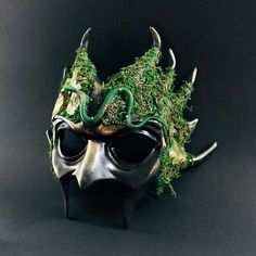 Venture into the heart of the enchanted woods with our Forest Emerald Ent Mask. Adorned with lush green moss and creeping vines, this mask embodies the spirit of ancient forest guardians, perfect for nature-themed events or mystical gatherings. Additional product details: All our masks come with Ribbons or elastic bands attached unless it’s a handheld stick mask Size/Type: One Size Fits Most Mask Color: Dark Green with Natural Accents Mask Material: High-Quality Resin and Natural Moss Accent Mat Mardi Gras Kid, Kids Party Packs, Woodland Realm, Creeping Vines, Enchanted Wood, Female Mask, Mask Masquerade, Ancient Forest, Themed Events