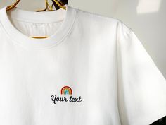 We offer a high quality custom embroidery service where you can embroider your favorite text and graphics on the t-shirt to make it your unique garment. Our t-shirts are made of 100% cotton, loose and comfortable, breathable and perfect for everyday wear. You can choose your favorite color from the color options we offer and have your text and graphics embroidered on the t-shirt. This would be a unique gift for yourself or your loved ones and family~. The embroidery technique we use is machine e White T-shirt With Machine Embroidery, Short Sleeve, White Crew Neck Tops With Machine Embroidery, Cotton Tops With Multicolor Embroidery And Logo, Multicolor Embroidered Cotton Crew Neck T-shirt, Casual T-shirt With Multicolor Letter Embroidery, Casual Multicolor Embroidered Letter T-shirt, Multicolor Embroidered Text Crew Neck T-shirt, White Embroidered Crew Neck T-shirt, Customizable White Top With Custom Embroidery