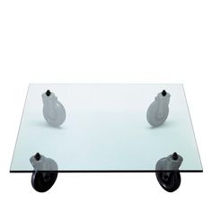 a glass table with two wheels on it