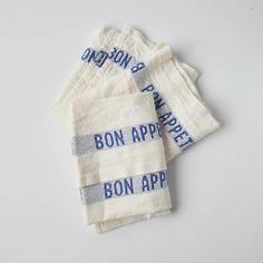 four napkins with bon apper written on them are sitting next to each other