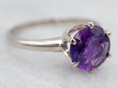 This ring is designed with luxurious white gold and a genuine amethyst stone. Its timeless single-stone design adds a sophisticated touch to any outfit, making it perfect for a special occasion.Metal: 14K White GoldGem: Amethyst 1.71 CaratsGem Measurements: 8.5 mm, RoundRing Size: 7.50Marks: "14K" Stamped on the inside band Luxury Amethyst Birthstone Ring For Anniversary, Elegant Amethyst Solitaire Ring With Round Stone, Elegant Purple Sapphire Solitaire Ring, Elegant Purple Solitaire Sapphire Ring, Classic Amethyst Birthstone Ring In White Gold, Classic Amethyst Birthstone Ring, Formal Fine Jewelry Amethyst Solitaire Ring, Elegant Amethyst Solitaire Ring With Round Band, Classic White Gold Amethyst Ring With Polished Finish