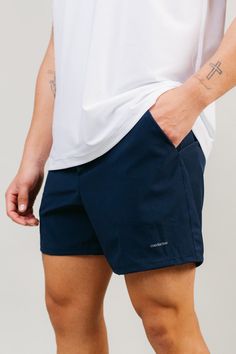 The perfect elevated workout shorts with a 5" inseam. Carefully crafted to give ultimate comfort, support and ease. The built-in lining with a phone pocket provides function, while the woven four way stretch fabric gives an elevated look to the utility of the shorts. Made in Los Angeles. Fits true to size. Model is wearing a size Large. #_Sweat-wicking, anti-microbial four way stretch fabric gives breathability and a soft hand. 88% Polyester, 12% Spandex Lining: 90% Polyester, 10% Spandex Machin Sports Shorts Mens, Mens 5 Inch Shorts Outfits, Casual Athletic Outfits Men, 5 Inch Inseam Shorts Men, Winter Drip, Spring Menswear, Husband Clothes, Spooky Basket, Summer Pieces