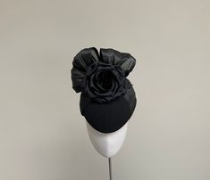 A beautiful and elegant  black felt cocktail style hat with black silk detail bow and rose.  This classic fascinator is made in black felt, and has a bow detail  on the crown in luxurious silk abaca, which continues down both  sides of the the hat.  To the front sits a beautiful black rose in layers of silk dupion to offset the bow.  This gorgeous headpiece is fitted with a fine elastic which is in a colour to blend in with your hair.  This fascinator measures 20cm front to back and 17cm side to side.  The perfect hat for a winter wedding or formal occasion, where elegance is required. Kentucky Derby Evening Hat With Satin Bow, Black Fitted Fascinator For Evening, Fitted Black Fascinator For Evening, Elegant Evening Hat With Satin Bow, Black Cloche Fascinator For Party, Elegant Party Fascinator With Satin Bow, Fitted Evening Hats With Bow, Black Cloche Fascinator For Evening, Fitted Cloche Fascinator For Evening