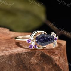 Unique coffin blue sandstone moon engagement ring cluster galaxy star amethyst wedding ring yellow gold bat custom proposal gift for women ITEM DETAILS: ❀Make every ring to order, all rings are handmade in the United States. ❀Metal: Solid 10K & 14K & 18K Gold ❀Gold Color: Rose gold, Yellow gold, White gold, Black gold Engagement Ring: ❥Main Stone:blue sandstone ☆Stone Shape: Coffin Shape ☆Stone Dimension: 6x9mm ☆Stone Weight: About 1.5 carat ☆Band Width: About 1.4mm ❥Accent Stones:Round Moissanite, Round amethyst ➽Customization◇◇ Gemstones can be replaced. For further personalization, gemstones, and curviness of the bands can be modified to align with your preferences. If you have any customization requirements,simply get in touch and let us know what you need.  ➽Ring Size◇◇ We can make th Moon Engagement Ring, Blue Sandstone Ring, Wedding Ring Yellow Gold, Black Gold Engagement Rings, Amethyst Wedding Ring, Engagement Ring Cluster, Amethyst Wedding Rings, Amethyst Wedding, Ring Cluster