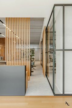 an office with wood slats and glass walls