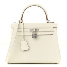 This is an authentic HERMES Togo Kelly Retourne 25 in Mushroom. This chic and iconic handbag is expertly handcrafted of grained calfskin leather in off white. The bag features rolled leather top handles, a short front flap with a strap closure with gold plated hardware including a padlock and leather covered keys, as well as an optional shoulder strap. The top flap opens to a matching goatskin leather interior with zipper and patch pockets. Hermes Crossbody Bag, Oversized Bag, Hermes Bags, Leather Cover, Leather Interior, Leather Top, Mini Bag, Calf Skin, Dolce And Gabbana