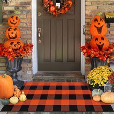 the front door is decorated with pumpkins and gourds