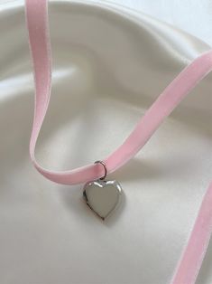 Oh it’s love... Introducing the most heavenly necklace to ever exist! Handcrafted with stunning pale pink velvet and your choice of a 14K gold or stainless steel heart locket, the 'FOREVER YOURS' is bound to become a treasured piece in your jewelry collection. Trust us, compliments are coming your way. Made with vintage, deadstock pale pink velvet and 14K gold plated or stainless steel pendant. 45" length - designed to allow you to tie this piece in multiple ways. Handmade with love in Los Angel Pink Heart Pendant Necklace With Locket, Pink Heart-shaped Choker As A Gift, Pink Heart Choker As Gift, Pink Heart-shaped Choker For Gifts, Heart Choker With Charm For Valentine's Day, Heart Charm Choker For Valentine's Day, Pink Heart-shaped Choker Gift, Heart Shaped Choker With Heart Charm For Valentine's Day, Pink Heart-shaped Choker For Valentine's Day