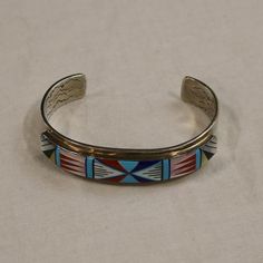 Glacier Wear : Fine Furs and Leather Since 1991Ornamental Inlay Cuff Braceletjwl1104Inlay Cuff Bracelet with Mother of Pearl, Onyx, Lapis, Turquoise and CoralNew Southwestern Native American Sterling Silver Cuff Bracelet.One of a kind, truly special and unique.Approx. 2 3/4" wide by 5/8" high.Internal circumference approximately 7 1/4".We also stock the largest inventory of tanned furs and leather hides in North America. Visit us at Glacier Wear. Multicolor Cuff Bangle Bracelet, Multicolor Bangle Cuff Bracelet, Southwestern Multicolor Cuff Bangle, Multicolor Cuff Jewelry For Gifts, Southwestern Style Multicolor Bracelet Jewelry, Silver Inlay Cuff Bracelet Bangle, Traditional Inlay Cuff Bangle Bracelet, Southwestern Style Multicolor Bracelet, Southwestern Style Multicolor Bangle Jewelry