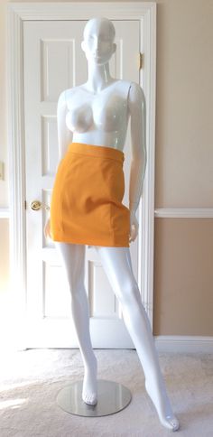 "This vintage Moschino skirt is in his iconic taxi cab/school bus yellow.  Fully lined in yellow rayon.  Side zipper with self button.  Front and back shaping seams.  Measurements -  Waist - 27' Hips - 36\" Length - 18\"" Chic Fitted Yellow Pencil Skirt, Chic Yellow Fitted Pencil Skirt, Chic Fitted Yellow Skirt, Retro High-waist Fitted Mini Skirt, Retro Fitted High Waist Mini Skirt, Retro Fitted High-waist Mini Skirt, Fitted High Waist Retro Mini Skirt, Yellow Workwear Bottoms Shorts, Yellow Short Bottoms For Work