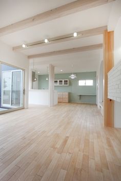 an empty room with wood floors and white walls