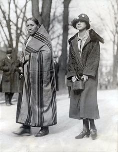 two women standing next to each other in the snow