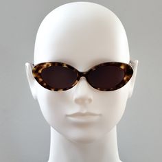 Round Cateye sunglasses.  Tortoiseshell acetate frame with black lenses.  Frame Specs: Lens Category 3 UV400 100% UV Protection Acetate Frame Lens Height: 32mm, Lens Width: 50mm, Sunglass Length (including frame): 143mm Classic Acetate Cat Eye Sunglasses With Tinted Lenses, Retro Acetate Sunglasses With Uv Protection, Classic Acetate Cat Eye Sunglasses With Uva Protection, Retro Acetate Sunglasses With Tinted Lenses, Modern Brown Acetate Cat Eye Sunglasses, Retro Sunglasses With Tinted Lenses, Classic Cat Eye Sunglasses For Beach, Classic Acetate Cat Eye Sunglasses With Polarized Lenses, Classic Cat Eye Sunglasses With Polarized Acetate Lenses