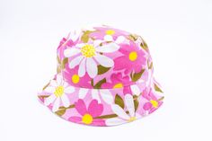 SUMMER BUCKET HAT * PINK VINTAGE FABRICK with FLOWERS * TWO SIDES bucket hat. ( WHITE or STRIPED). * Handmade and recycled from A to Z in Montreal.  Sizes Informations     SMALL/MEDIUM : 52 à 57 cm. MEDIUM : 54 à 60 cm. The circumference is measured with a metric ribbon around the head passing to the center of the forehead, the tip of the ears and the back of the skull. PLEASE TAKE THE MEASUREMENT OF YOUR HEAD. NO REFUND WILL BE ACCEPTED.  DELIVERY: from 1 to 2 weeks  Do not hesitate to contact Vintage Cotton Sun Hat For Summer, Retro Pink Summer Hat, Retro Pink Brimmed Hat, Retro Pink Cotton Hat, Retro Pink Wide Brim Hat, Retro Handmade Bucket Hat For Summer, Handmade Retro Bucket Hat For Summer, Vintage Handmade Bucket Hat For Spring, Vintage Adjustable Bucket Hat For Summer