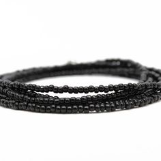 Black Wrap Seed Bead Bracelet – Kathy Bankston Bohemian Black Multi-strand Beads, Black Bohemian Wrap Bracelet With Round Beads, Bohemian Black Bracelets With Polished Beads, Bohemian Black Bracelet With Polished Beads, Black Bohemian Bracelet With Polished Beads, Minimalist Black Hand-strung Beaded Bracelets, Minimalist Black Hand-strung Beaded Bracelet, Minimalist Hand-strung Black Beaded Bracelets, Beach Black Beaded Necklace With Tiny Beads