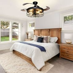 a bed room with a neatly made bed and a ceiling fan in the middle of it