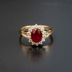 This beautiful oval ruby diamond ring is inspired by princess Diana's engagement ring. It features a central 1.75 carat deep red sapphire gemstone surrounded by 0.47 carat natural diamonds - an elegant, timeless piece of jewelry. Main Stone Ruby Shape: Oval Carat: 1.75 carat Color: Red Cut: Very Good Side stones: Natural Diamonds Shape: Round brilliant Carat: 0.47 carat Color: D - F Clarity: VS1 - VS2 Cut: Very Good - Excellent 18K Yellow Gold Total Ring Weight: 4.12 g -- WHY CHOOSE US -- We dea Yellow Engagement Ring, Princess Diana Engagement Ring, Engagement Ring Elegant, Diana Engagement Ring, Ruby Ring Designs, Oval Cut Moissanite Engagement Ring, Halo Wedding Ring, Red Sapphire, Ring Elegant