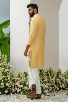 Yellow placed floral thread and cutdana embroidered kurta with mirrorwork. Comes with bell bottom pant.
Components: 2
Pattern: Embroidered
Type Of Work: Thread, Cutdana
Neckline: Mandarin Collar
Sleeve Type: Full
Fabric: Kurta: Raw Silk, Bellbottom: Cotton Silk
Color: Yellow
Other Details: 
Closure: Kurta: Front button
Occasion: Sangeet,Mehendi and Puja - Aza Fashions Raw Silk Straight Kurta With Dabka, Designer Slub Silk Sherwani With Traditional Drape, Raw Silk Kurta With Cutdana For Diwali, Cotton Silk Sherwani With Dabka, Straight Kurta Style, Bollywood Style Straight Kurta Sherwani In Slub Silk, Sherwani With Dabka In Cotton Silk, Dabka Embellished Cotton Silk Sherwani, Bollywood Style Sherwani In Slub Silk, Unstitched Raw Silk Kurta For Festivals