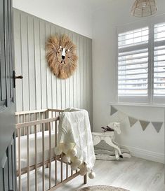 a baby's room is decorated in white and neutrals