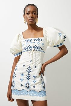 Crafted With Contrasting Embroidery Motifs, This Piece Goes Seamlessly From Day To Night, A True Summer Staple. It Features A Square Neckline That Accentuates The Bust And Embroidery Adornes The Entire Garment. Complete With Puffed Sleeves, This Piece Can Be Easily Styled With Sandals Or Strappy Heels For A Summer Look To Keep Reaching For. Cotton Embroidered Puff Sleeve Woven Mini Dress High Quality Cotton Fabric Contrasting Embroidered Details Flattering Straight Fit Sophisticated Square Neckl Blue And White Sundress, Modest Cute Dresses, Long Church Dresses, Senior Picture Dresses, European Fashion Aesthetic, Blue Puff Sleeve Dress, Cotton Dresses Summer, Hen Do Outfits, White And Blue Dress