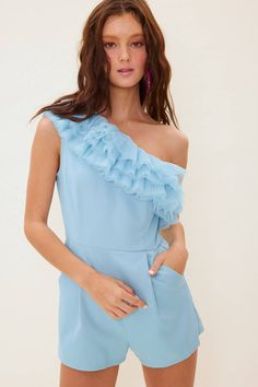 The sweetest little romper featuring one shoulder and pleated tulle detail. Side zipper and pockets. 100% polyester Fitted One-shoulder Jumpsuit With Ruffles, One-shoulder Fitted Jumpsuit With Ruffles, Fitted One-shoulder Ruffled Jumpsuit, Spring One Shoulder Ruffled Jumpsuits And Rompers, Spring One-shoulder Ruffled Jumpsuits And Rompers, One-shoulder Ruffled Jumpsuits And Rompers For Spring, Chic One Shoulder Ruffled Jumpsuit, Chic One-shoulder Ruffled Jumpsuit, Spring Jumpsuits And Rompers With Asymmetrical Neckline