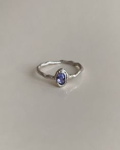 Introducing our Handcrafted Blue Tanzanite Silver Ring, a unique piece designed for individuality and elegance. This one-of-a-kind ring seamlessly combines the timeless allure of silver with the captivating beauty of Tanzanite. Tanzanite, known for its vibrant blue hue, is a gemstone associated with spiritual awareness and clarity. It is believed to promote inner wisdom and inspire a sense of calmness. Each ring is crafted as a singular piece, making it exclusive and distinctive. Embrace the enc Blue Tanzanite Birthstone Ring, Tanzanite Sapphire Ring As Gift, Tanzanite Topaz Gemstone Ring As Gift, Oval Tanzanite Halo Jewelry, Elegant Blue Tanzanite Birthstone Ring, Blue Tanzanite Rings For Promise, Silver Tanzanite Fine Jewelry, Silver Tanzanite Birthstone Ring With Accent Stones, Elegant Sapphire Tanzanite Ring In Silver Color