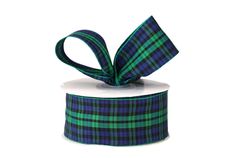 a green and black plaid ribbon with a bow on it's end, sitting on top of a white box