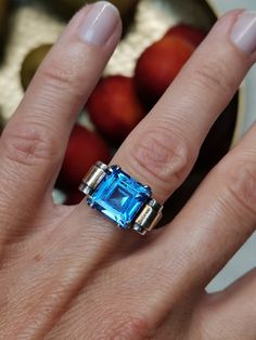 Antique French silver vermeil Art Deco ring, circa 1930, geometric and round lines, it has a typical volume of this period. The ring is decorated with synthetic spinel of intense light blue color.  Wild Boar hallmark and French silver punch, in good antique condition, minor chips on the stone (two of the corners), invisible without jeweler loupe. Material: silver vermeil US size: 6 1/2 (EU 53) Weight: 4.9 g Modernist Hallmarked Wedding Rings, Modernist Blue Gemstone Jewelry, Unique Yellow Gold Topaz Ring For Formal Occasions, Modern Formal Hallmarked Topaz Ring, Art Deco Blue Topaz Ring With Center Stone, Modern Blue Sapphire Ring Hallmarked, Modern Gold Rings With Blue Topaz, Art Deco Gemstone Signet Ring For Formal Occasions, Formal Art Deco Gemstone Signet Ring