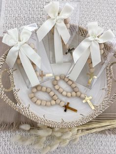 a white plate topped with wooden beads and crosses